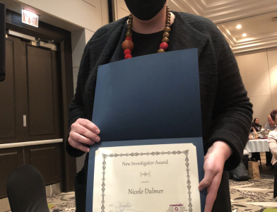 Image of Nicole Dalmer holding the New Investigator Award